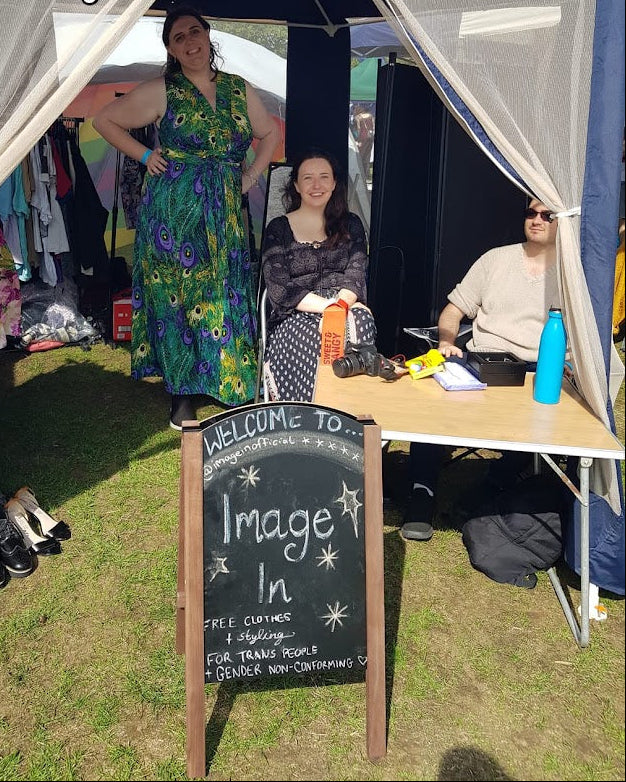 People standing under a tent with a 'Welcome to Image In' sign in the foreground.