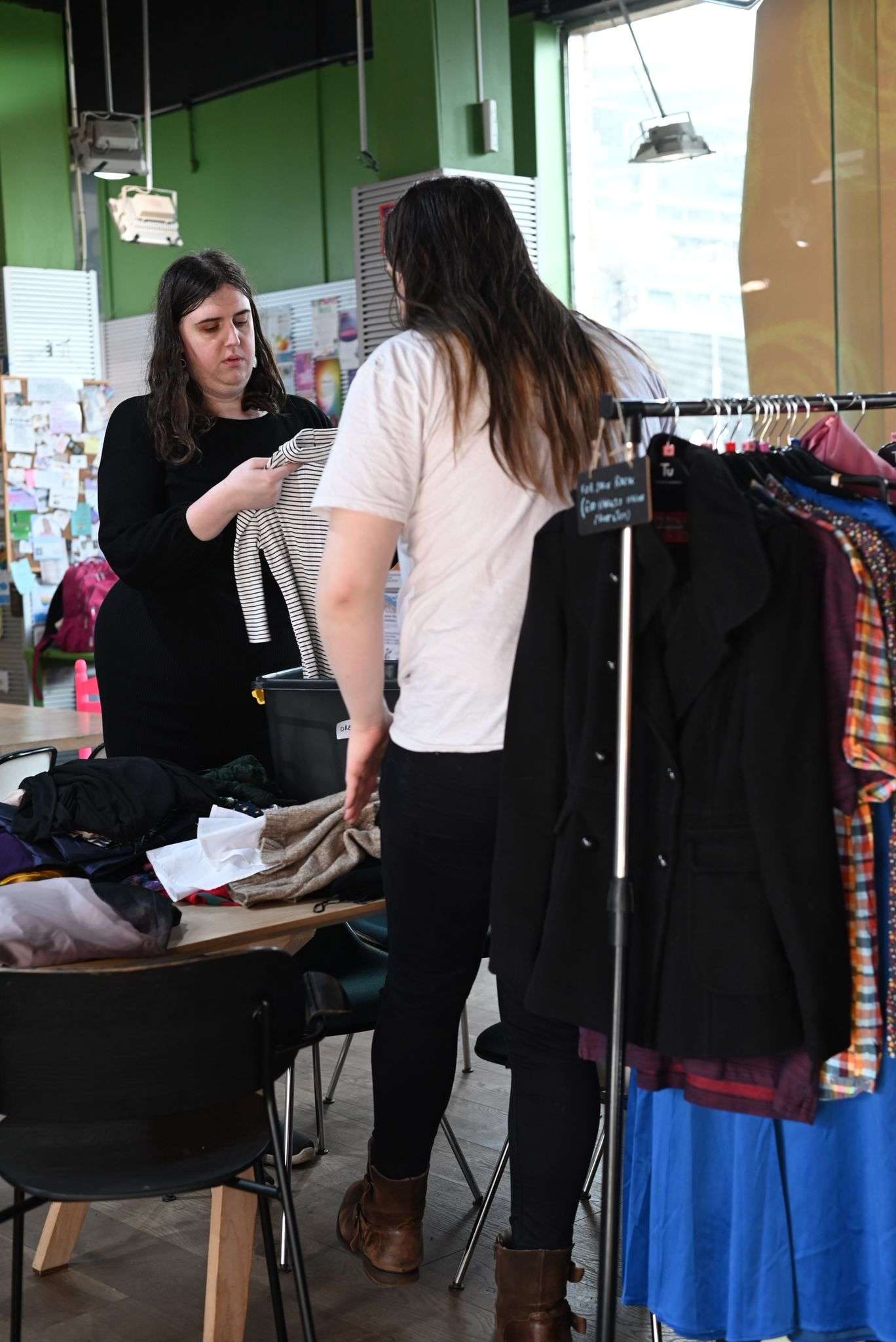 Volunteer sorting through donated clothing